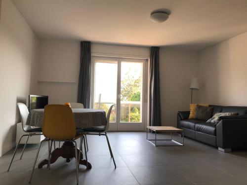 a living room with a couch and a table at Muralto-Locarno: Miramonti Apt. 17 in Locarno