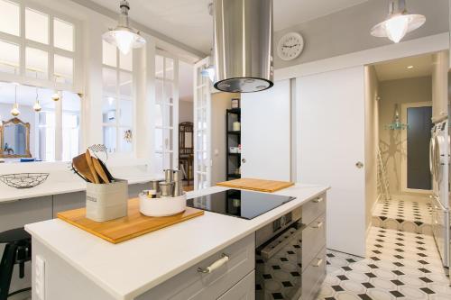 a kitchen with white counters and a counter top at Chiado Deluxe Gem 4bdr Amazing apartment in Lisbon