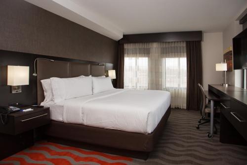 a hotel room with a large bed and a desk at Holiday Inn Express - Springfield Downtown by IHG in Springfield