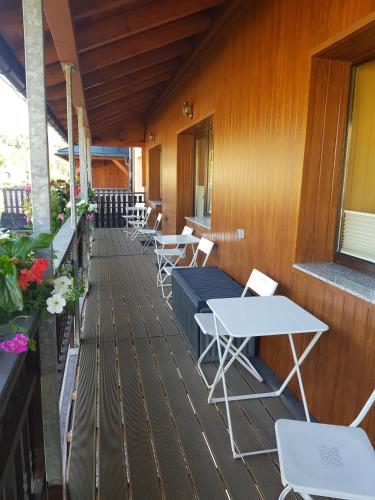 a row of tables and chairs on a balcony at Pension An der Erzgebirgsbahn in Kurort Oberwiesenthal