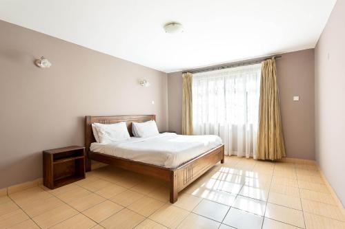 Ένα ή περισσότερα κρεβάτια σε δωμάτιο στο Prestige Riara 2 Bedroom Apartments