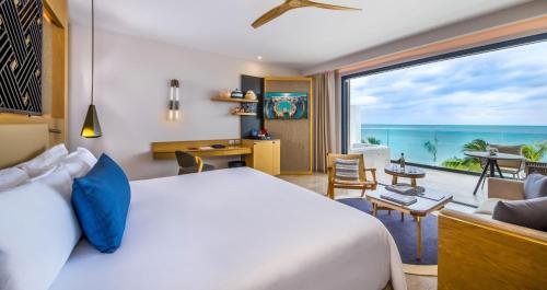 a bedroom with a bed and a view of the ocean at Haven Riviera Cancun - All Inclusive - Adults Only in Cancún