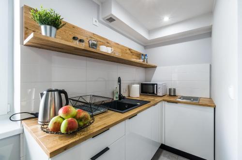 a kitchen with a bowl of fruit on a counter at Apartamenty Medyka Park in Medyka