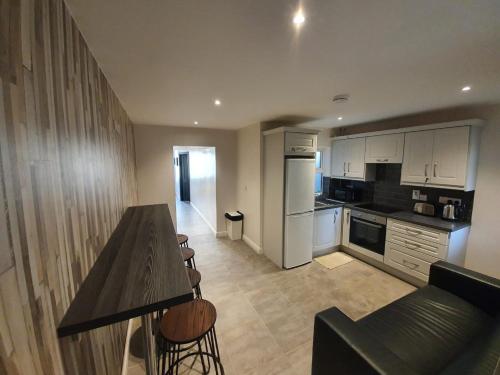 a kitchen and living room with a table and chairs at Large Townhouse in the Heart of Galway No 12 in Galway