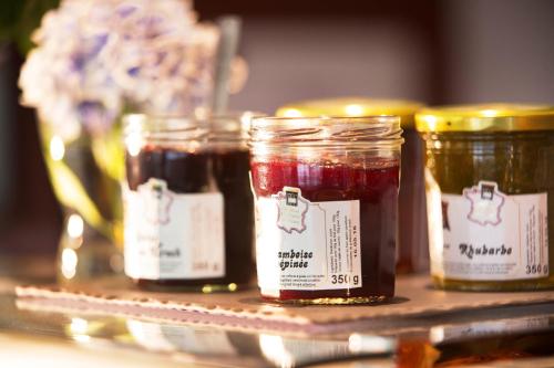 a group of four jars of jam on a shelf at Hôtel Diana Dauphine in Strasbourg