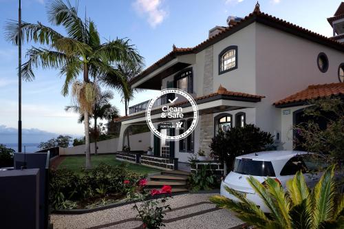 a house with a car parked in front of it at Gem of a House by Homie in Funchal