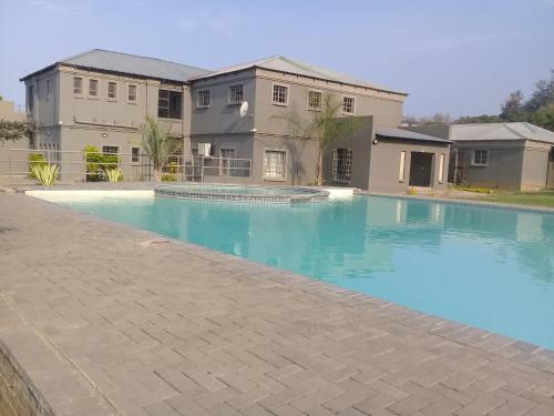 una gran piscina frente a una casa en SIMA SILVER LODGE, en Tzaneen