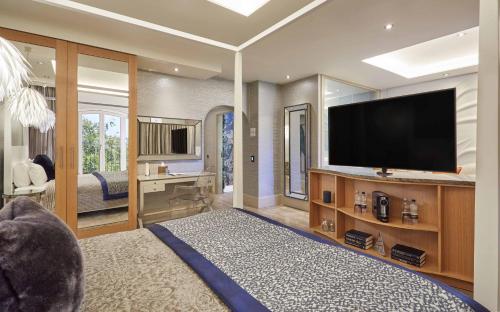 a living room filled with furniture and a tv at Lion Quays Resort in Chirk