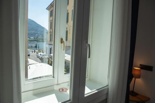 
a view through a glass door of a room at In Riva Al Lago in Como
