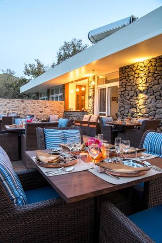 a wooden table with wine glasses on a patio at Wordsworth Lodge in Mount Ābu