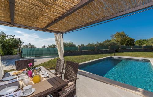 a patio with a table and a swimming pool at Terre Bianche with Private Pool and Whirlpool in Buje
