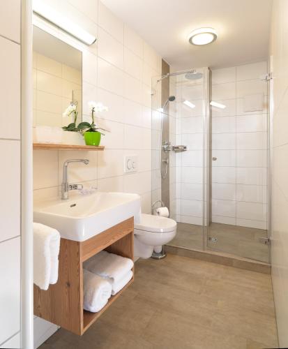 a bathroom with a sink and a shower at Hotel Garni Schieferle in Innsbruck