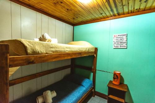 a bunk bed in a small room next to a wall at Bla Guest House in El Calafate
