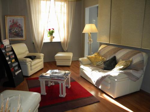 a living room with a couch and a table at Alerion Centre Gare in Metz