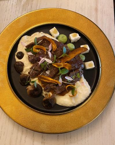 a plate of food with meat and vegetables on it at New York Pension in Dunajská Streda