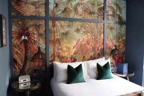 a bedroom with a bed with a large painting on the wall at The Market House in Reading