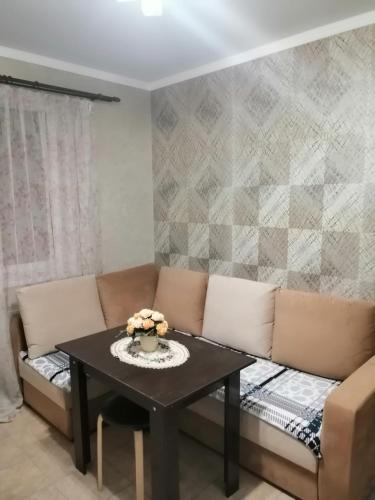 a living room with a couch and a table at Московская улица, 97 Апартаменты 5этаж in Pyatigorsk