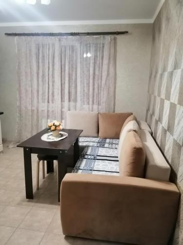 a living room with a couch and a table at Московская улица, 97 Апартаменты 5этаж in Pyatigorsk