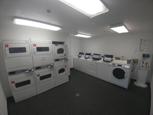 a laundry room with washing machines and a washer and dryer at InTown Suites Extended Stay Chicago IL - Downers Grove in Downers Grove