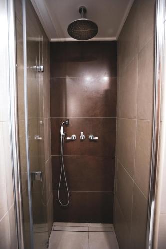 a bathroom with a shower with a glass door at Casas da Ribeira in Santa Bárbara
