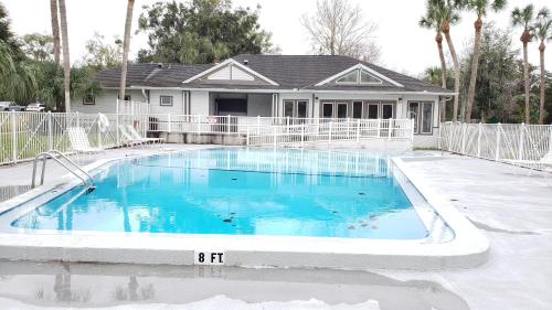 a swimming pool in front of a house at Comfy 1BR Apartment - Ideal for Traveling Nurses & Professionals in Gainesville