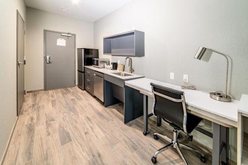 a kitchen with a desk and a sink in a room at Everglades Adventures Hotel Suites by Ivey House in Everglades City