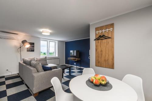 a living room with a table and a couch at Apartamenty Medyka Park in Medyka