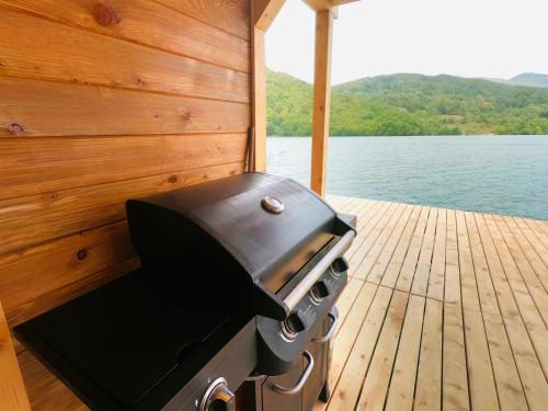 a bbq grill on the back of a boat at Lake House Perucac in Rastište