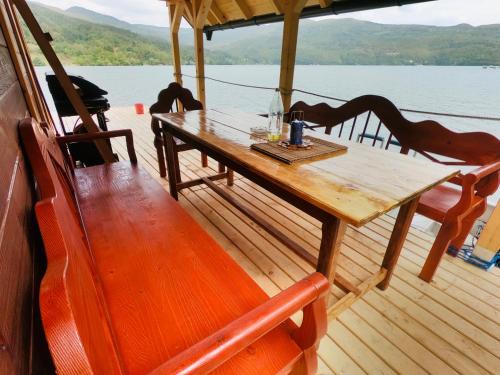 a wooden table on the deck of a boat at Lake House Perucac in Rastište