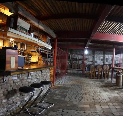 a room with a bar with stools in it at Albatros in Călăraşi