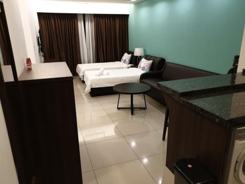 a living room with a bed and a couch at Studio Suite Genting Highland 32 in Genting Highlands