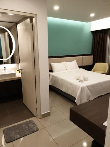 a hotel room with a bed and a sink at Studio Suite Genting Highland 32 in Genting Highlands