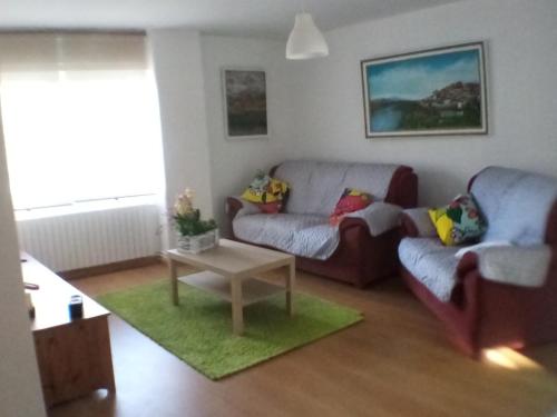 a living room with a couch and a table at Apartamento Tui, Casa da Barca in Tui
