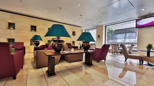 een lobby met een bank en een tafel met twee lampen bij Crowne Plaza Hamra Beirut, an IHG Hotel in Beiroet