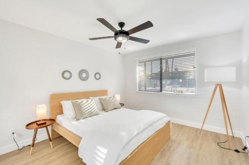 a white bedroom with a bed and a ceiling fan at Modern Contemporary OT Scottsdale with Heated Pool in Scottsdale
