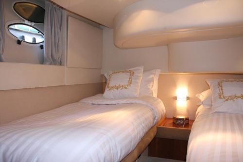 a small bedroom with two beds and a mirror at Porto Private Yacht- Accommodation Douro River in Porto