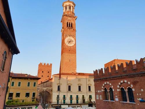 a clock tower on top of a building at Hotel Aurora in Verona