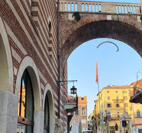 a brick building with an archway on a city street at Hotel Aurora in Verona
