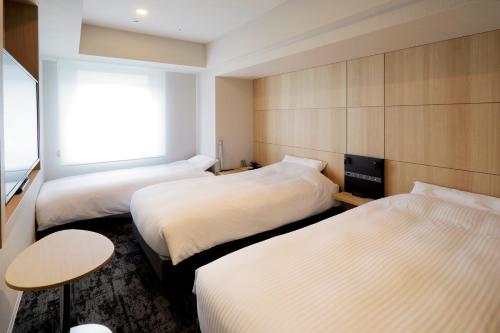 Ένα ή περισσότερα κρεβάτια σε δωμάτιο στο JR Inn Sapporo Kita 2 Jo