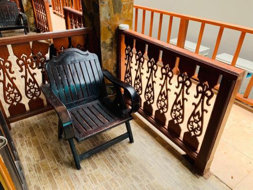 a wooden chair sitting next to a stair railing at Delight Resort in Haad Rin