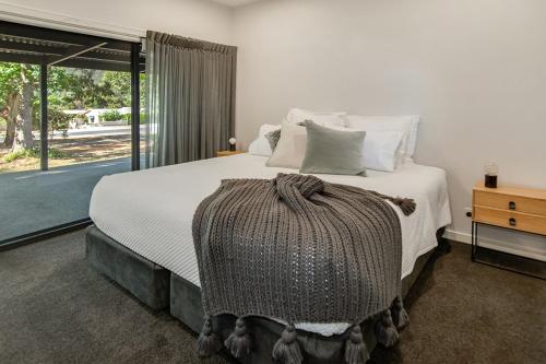 a bedroom with a large bed and a window at Central Views Halls Gap in Halls Gap