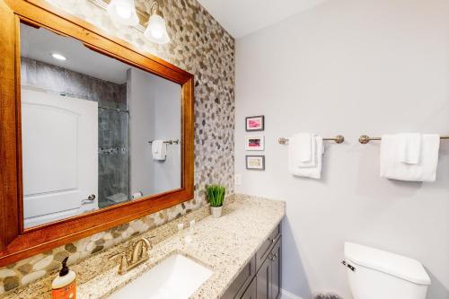 a bathroom with a sink and a mirror at Townsend Timbers in Townsend