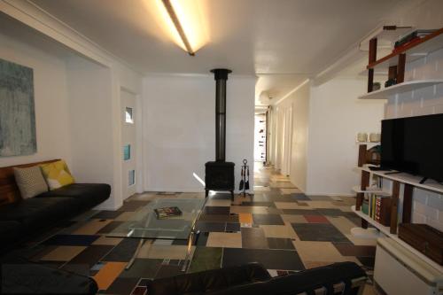 a living room with a couch and a fireplace at Up cycle House Blackheath in Blackheath