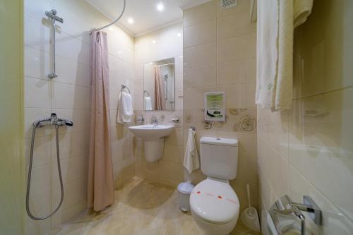 a bathroom with a toilet and a sink and a shower at BSA Gradina Hotel & Aquapark - All Inclusive in Golden Sands