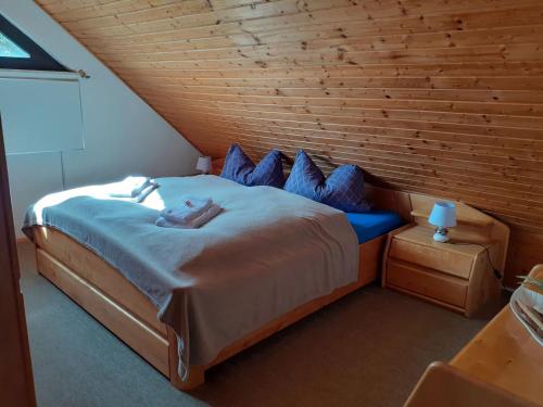 a bedroom with a large bed with blue pillows at Ferienwohnung JuLe in Winterberg