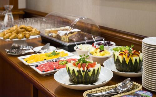 a buffet with many different types of food on a table at Bukowy Park Apartamenty in Polanica-Zdrój
