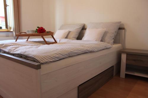 a bed with a table on top of it at Apartmán Domčeková in Košice