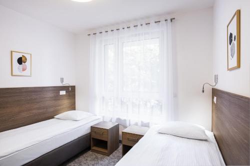 Ένα ή περισσότερα κρεβάτια σε δωμάτιο στο Bukowy Park Apartamenty
