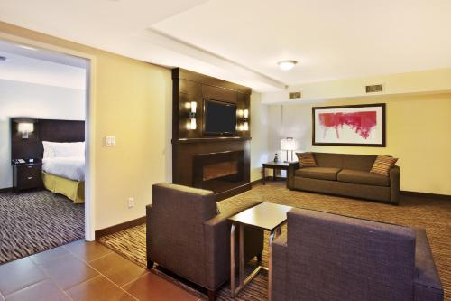 a hotel room with a couch and a bed at Holiday Inn Express - Sault Ste. Marie by IHG in Sault Ste. Marie