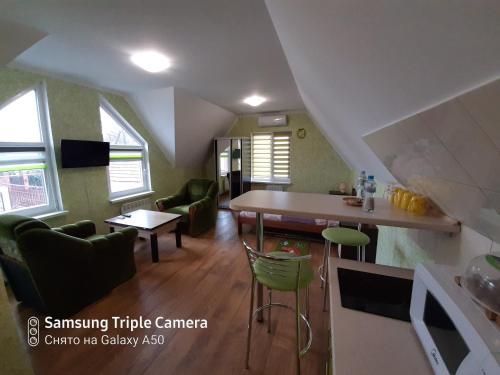 a kitchen and living room with a table and chairs at Rand in Fontanka